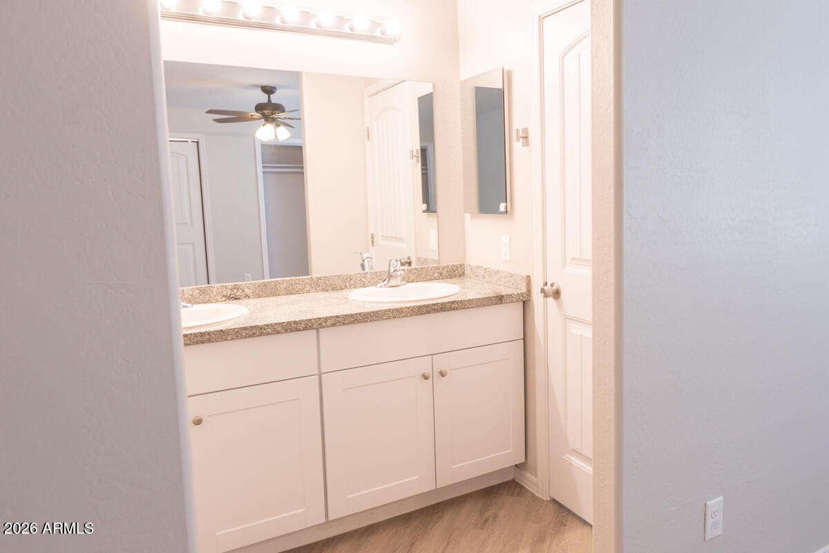 24638 East Bartlett Road Florence, AZ 85132 - Photo 12 of 21 a bathroom with a double vanity sink and a mirror