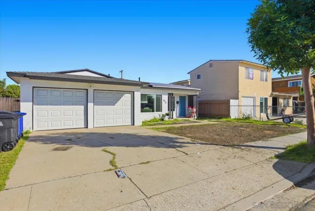a front view of a house with a garden and entryway
