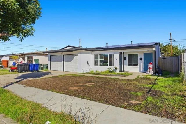 a view of a white house with a large yard and large tree