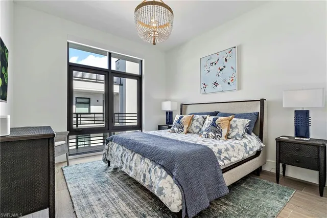 a bedroom with bed and wooden floor