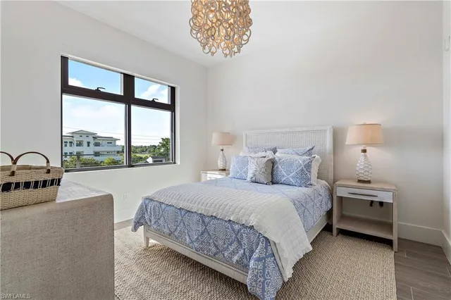 a bedroom with a large bed and a large window