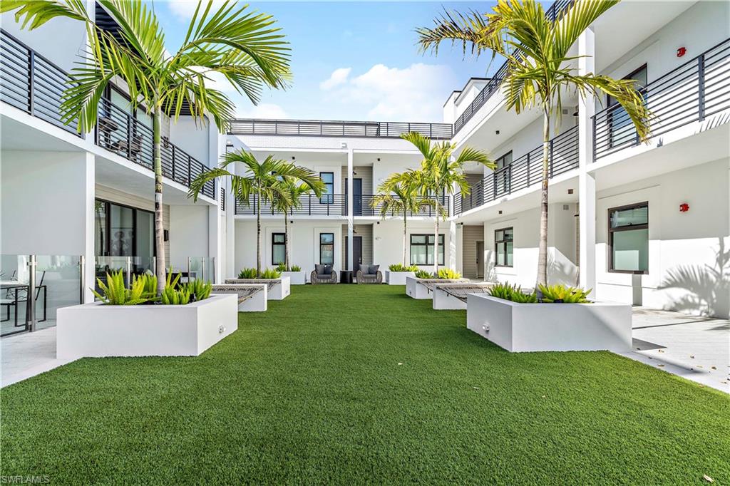 850 Central Avenue, Unit 310 Naples, FL 34102 - Photo 17 of 21 a view of a house with backyard and sitting area