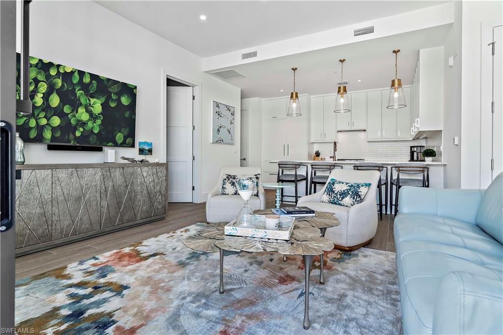 850 Central Avenue, Unit 310 Naples, FL 34102 - Photo 3 of 21 a living room with furniture and a flat screen tv
