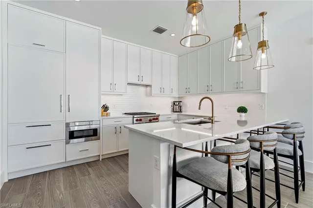 a kitchen with a sink cabinets and wooden floor