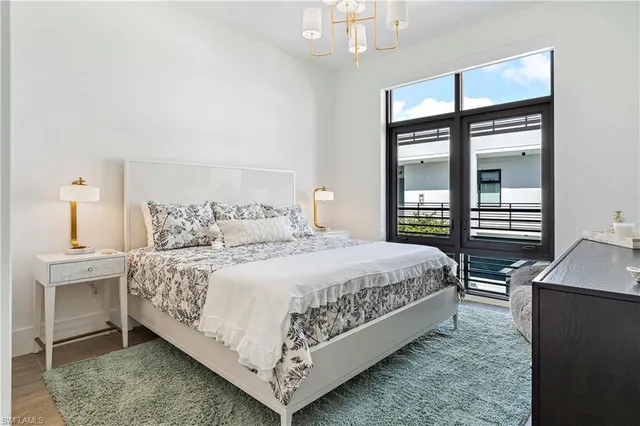 a bedroom with a large bed and a desk