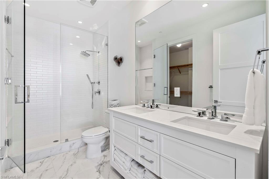 850 Central Avenue, Unit 310 Naples, FL 34102 - Photo 10 of 21 a bathroom with a sink a toilet and shower