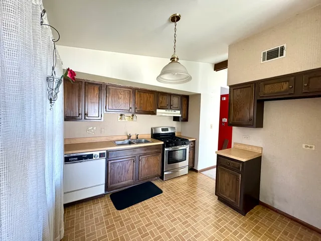 a kitchen with a refrigerator and a stove