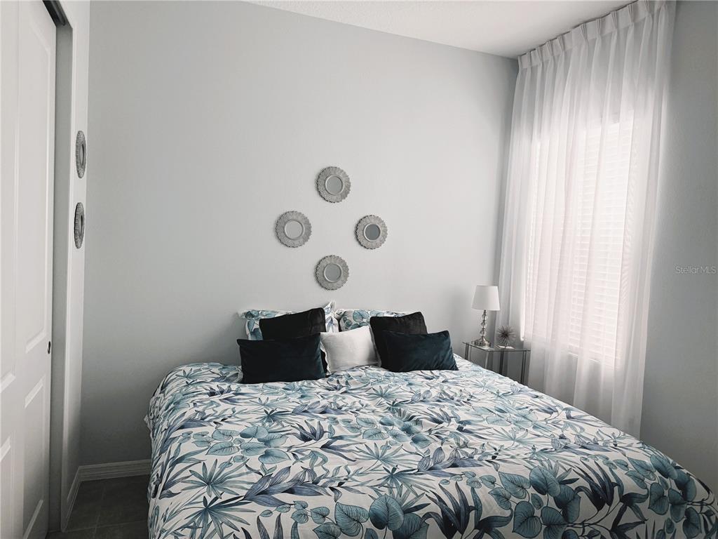 2031 Key Bay Trail Kissimmee, FL 34747 - Photo 18 of 46 a bedroom with a bed and a window