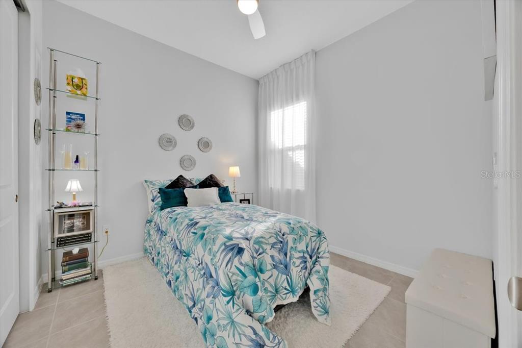 2031 Key Bay Trail Kissimmee, FL 34747 - Photo 19 of 46 a bedroom with a bed and a chandelier