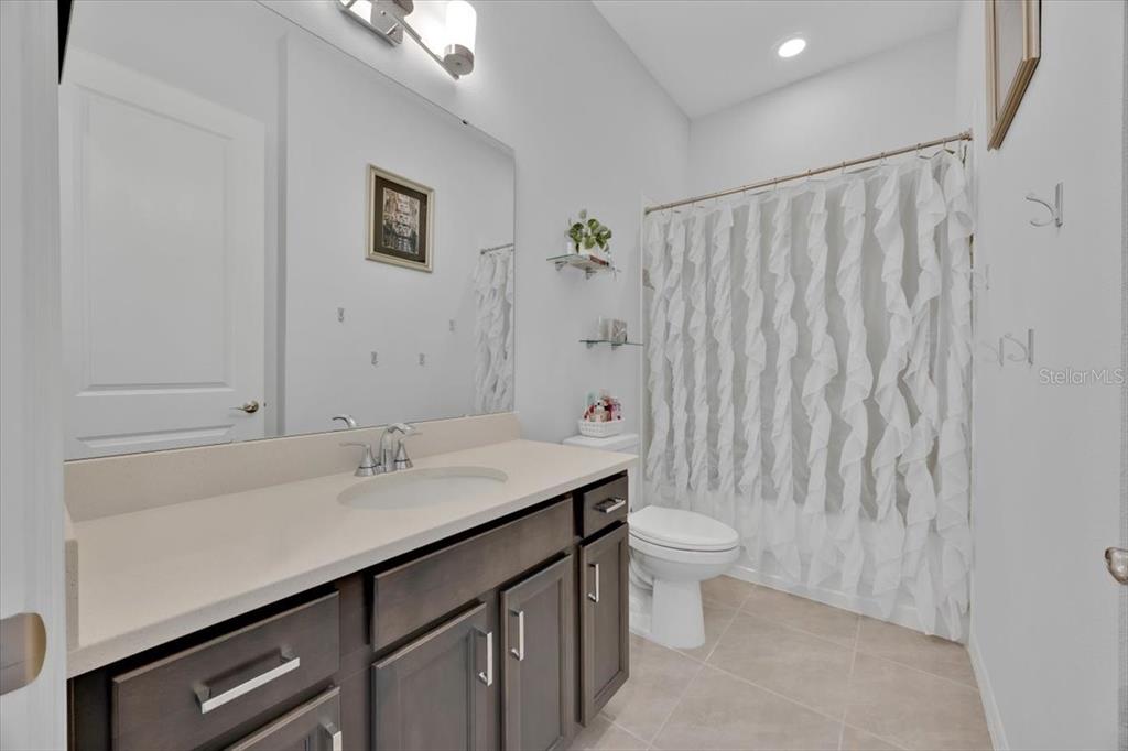2031 Key Bay Trail Kissimmee, FL 34747 - Photo 24 of 46 a bathroom with a sink a toilet and shower curtain