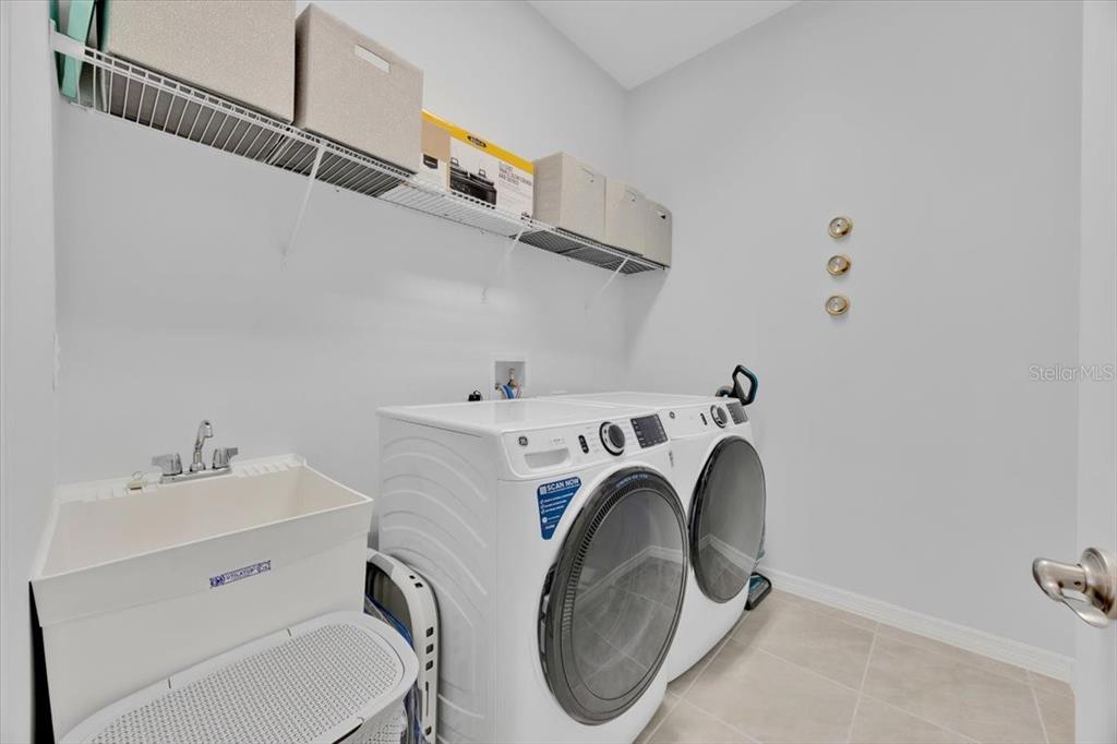 2031 Key Bay Trail Kissimmee, FL 34747 - Photo 28 of 46 a utility room with dryer and washer