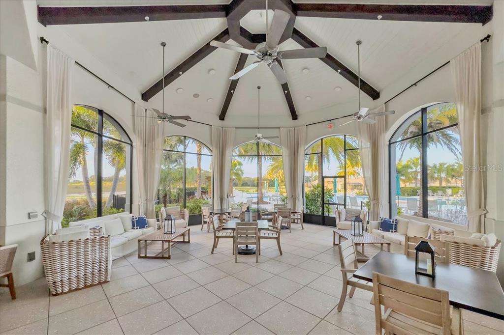 2031 Key Bay Trail Kissimmee, FL 34747 - Photo 42 of 46 a room with lots of white furniture and large windows