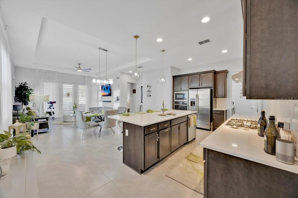 2031 Key Bay Trail Kissimmee, FL 34747 - Photo 8 of 46 a kitchen with a sink a counter top space and stainless steel appliances