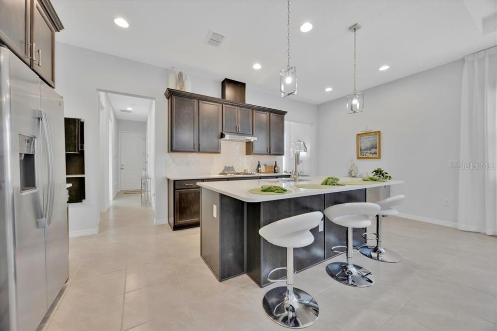 2031 Key Bay Trail Kissimmee, FL 34747 - Photo 9 of 46 a kitchen with kitchen island a sink stove and refrigerator