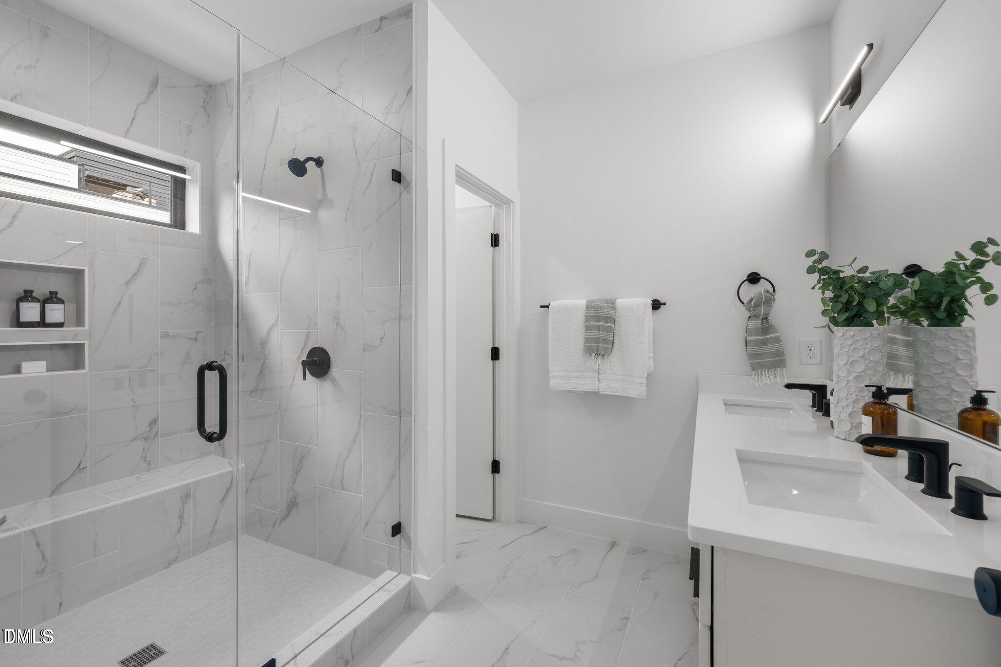 516 Edgecreek Court Raleigh, NC 27604 - Photo 19 of 26 a bathroom with a sink a mirror and shower