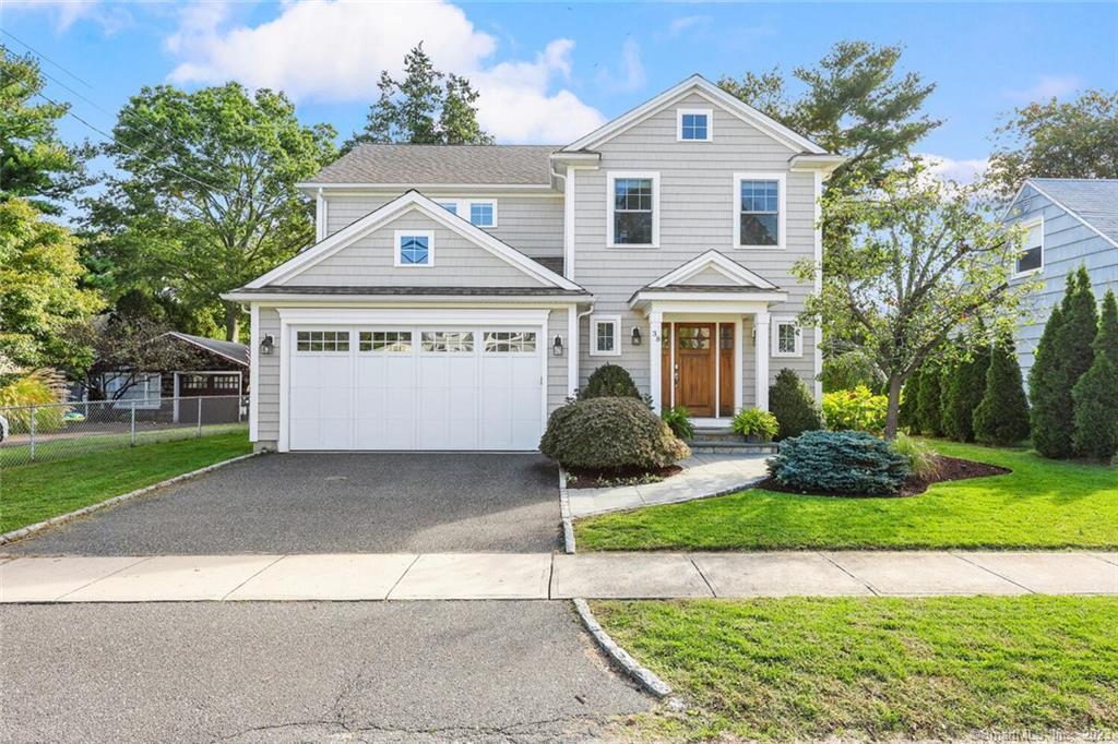 38 Arbor Terrace Fairfield, CT 06890 - Photo 1 of 1 a front view of a house with a yard and garage