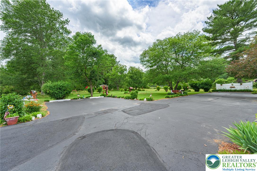 678 Interchange Road Kresgeville, PA 18333 - Photo 42 of 45 Ample asphalt driveway leads to a generous, tree-filled yard.