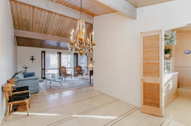 a dining room with furniture and a chandelier