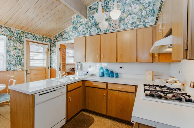 a kitchen with a sink stove and cabinets