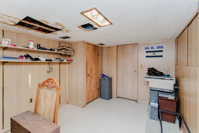 a bedroom with a bed and cabinets