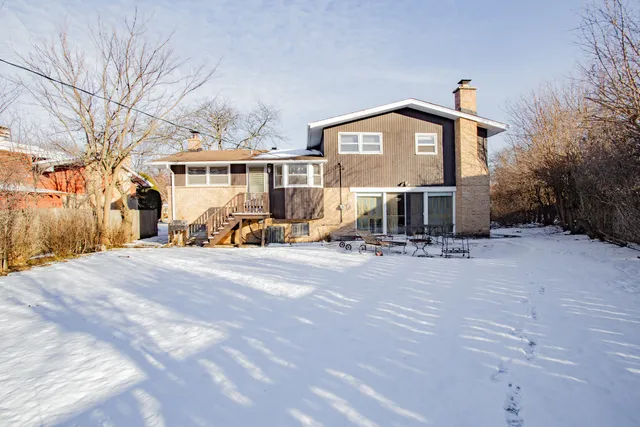 a view of a house with large trees in front of it