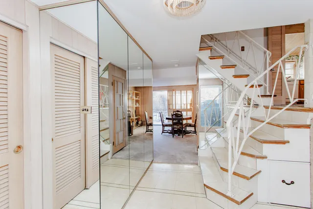 a view of living room filled with furniture and a chandelier
