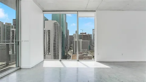 an empty room with windows and outdoor view