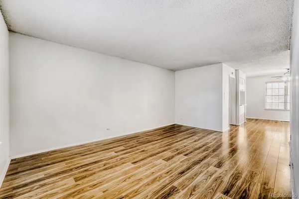 a view of empty room with wooden floor