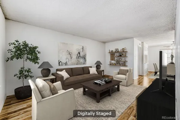 a living room with furniture potted plant and a table