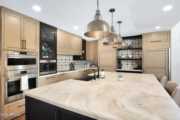 a bathroom with a double vanity sink mirror and bathtub