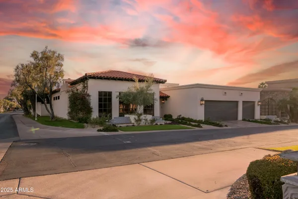 a living room with furniture chandelier and a large window