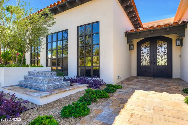 a living room with furniture a chandelier and a fireplace