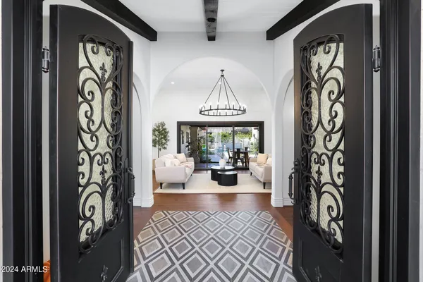 a living room with furniture a rug and a large window