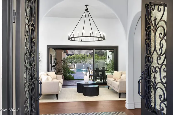 a living room with furniture and a large window with garden view
