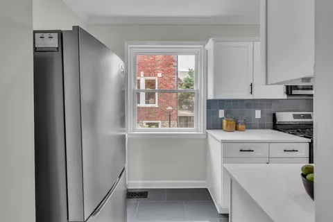 a kitchen with stainless steel appliances granite countertop a sink stove and cabinets