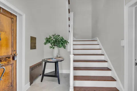 a view of a hallway with furniture and a potted plant