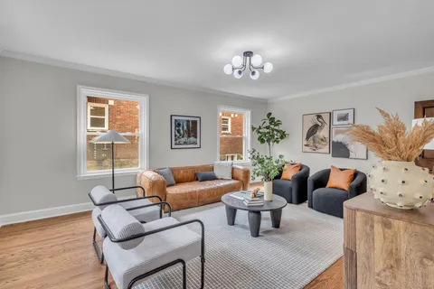 a living room with furniture and a chandelier