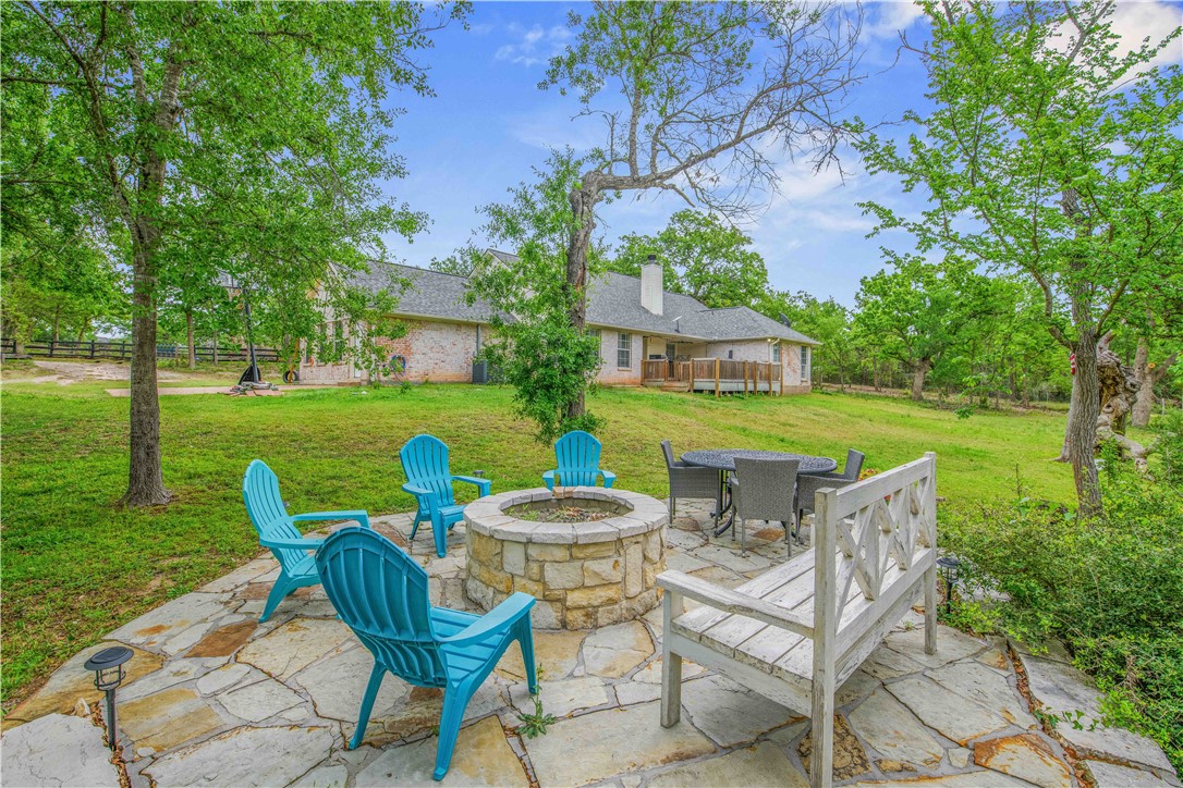 6538 Olympia Buddy Road College Station, TX 77845 - Photo 36 of 50 a view of a chairs and table in backyard of the house