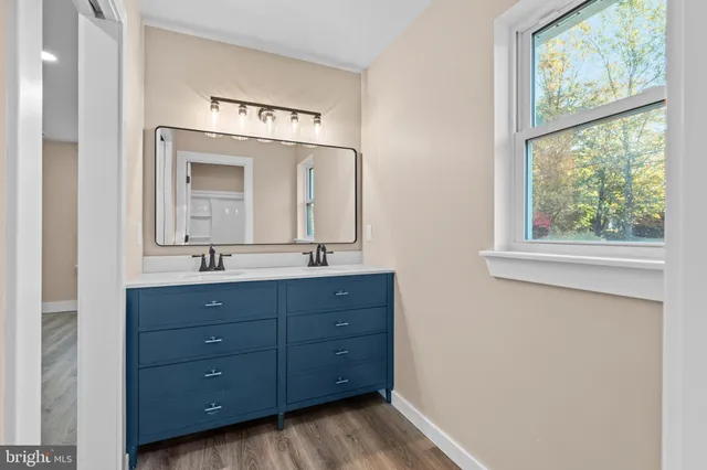 a bathroom with a double vanity sink and a mirror