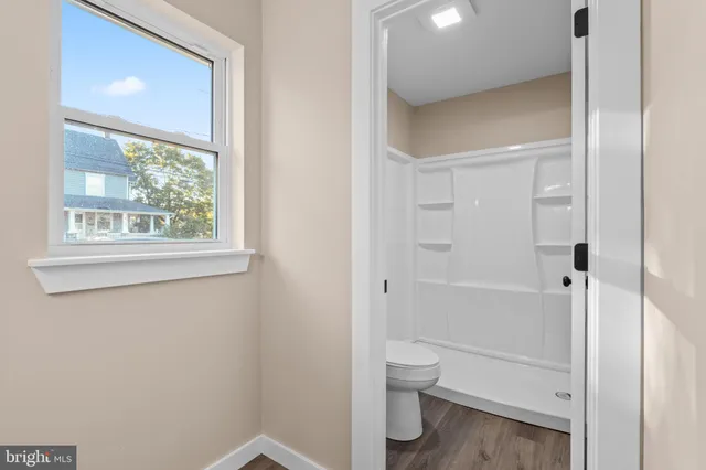 a bathroom with a toilet and a shower