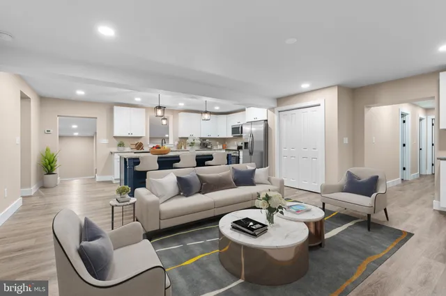 a living room with furniture kitchen and a table