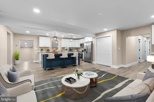 a living room with furniture and kitchen view