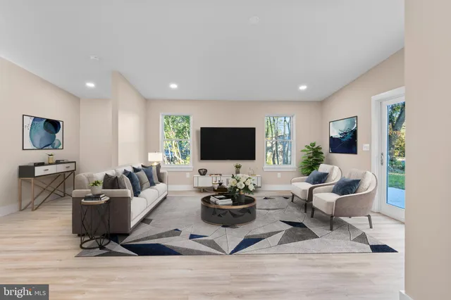 a living room with furniture wooden floor and a flat screen tv