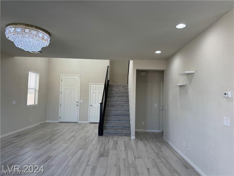 9056 Tony Ridge Avenue Las Vegas, NV 89148 - Photo 4 of 32 A spacious entry area boasts lofty ceilings and elegant wood-look flooring, creating a welcoming first impression.