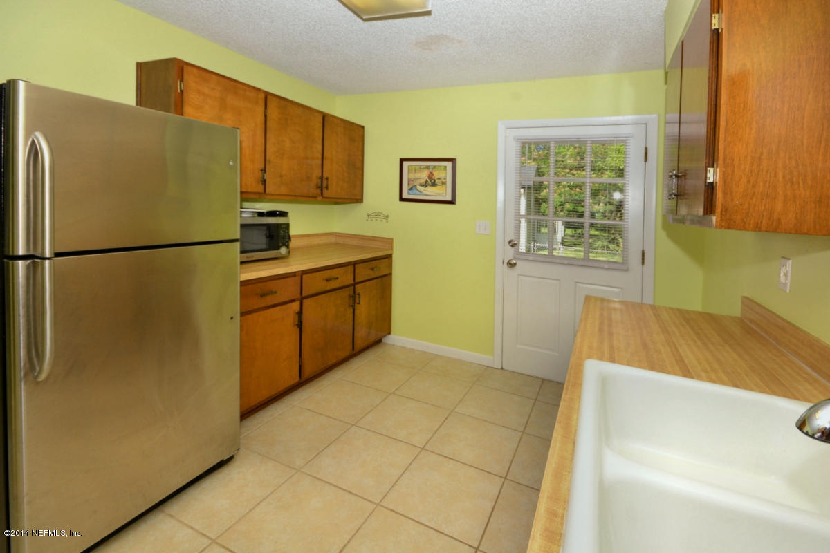 81 Kings Ferry Way St. Augustine, FL 32084 - Photo 11 of 24 a kitchen with stainless steel appliances a refrigerator and a sink