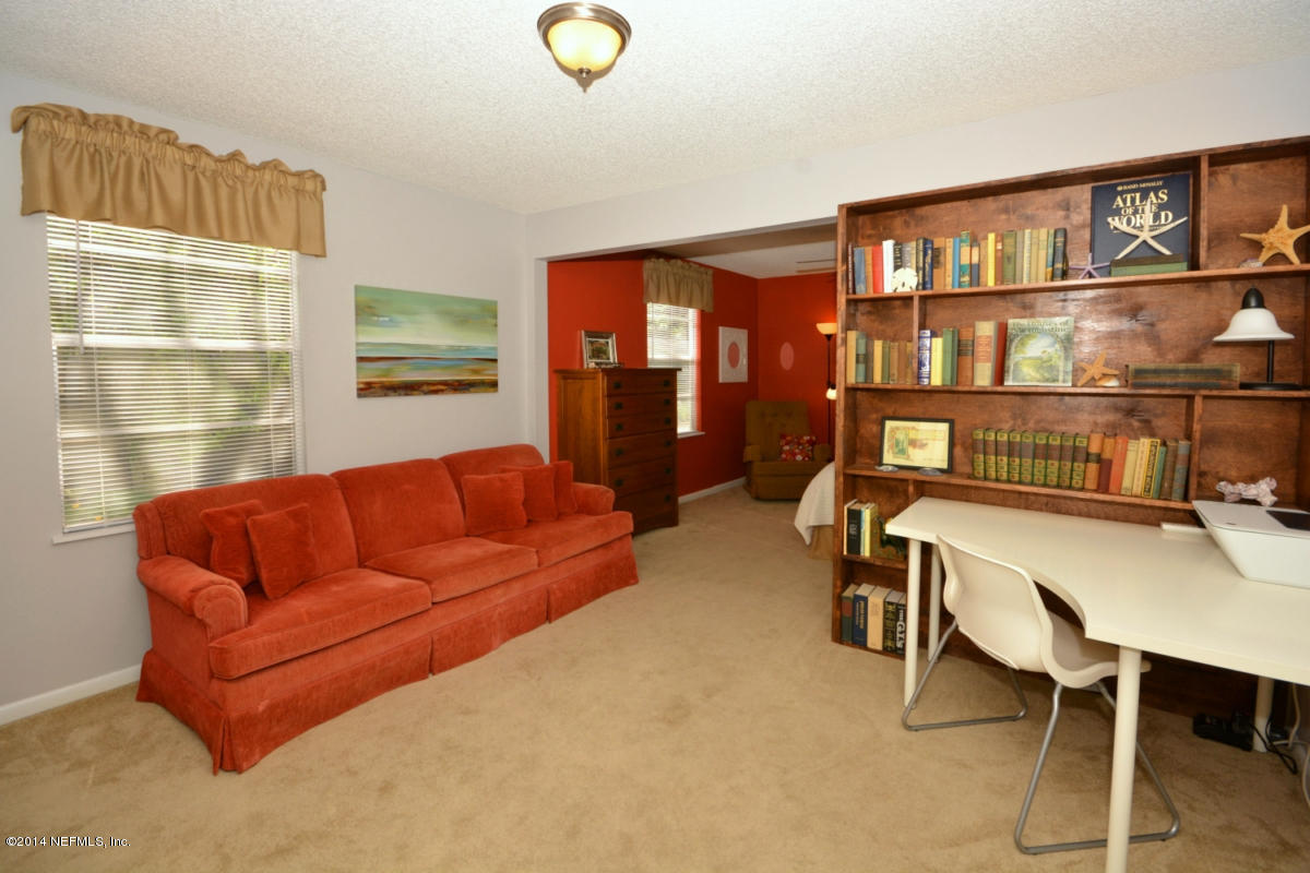 81 Kings Ferry Way St. Augustine, FL 32084 - Photo 13 of 24 a living room with furniture a rug and a window