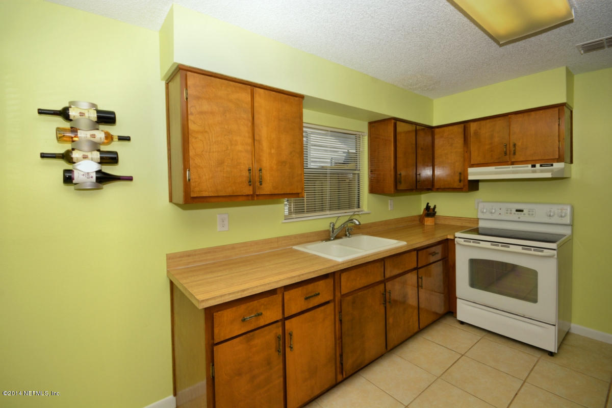 81 Kings Ferry Way St. Augustine, FL 32084 - Photo 9 of 24 a kitchen with a sink cabinets and appliances