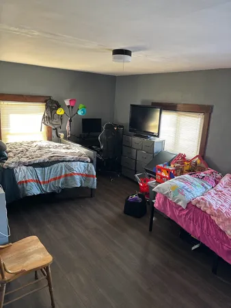 a bedroom with bed and a window