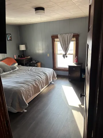 a bedroom with a bed and window
