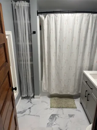 a bathroom with a bathtub and shower